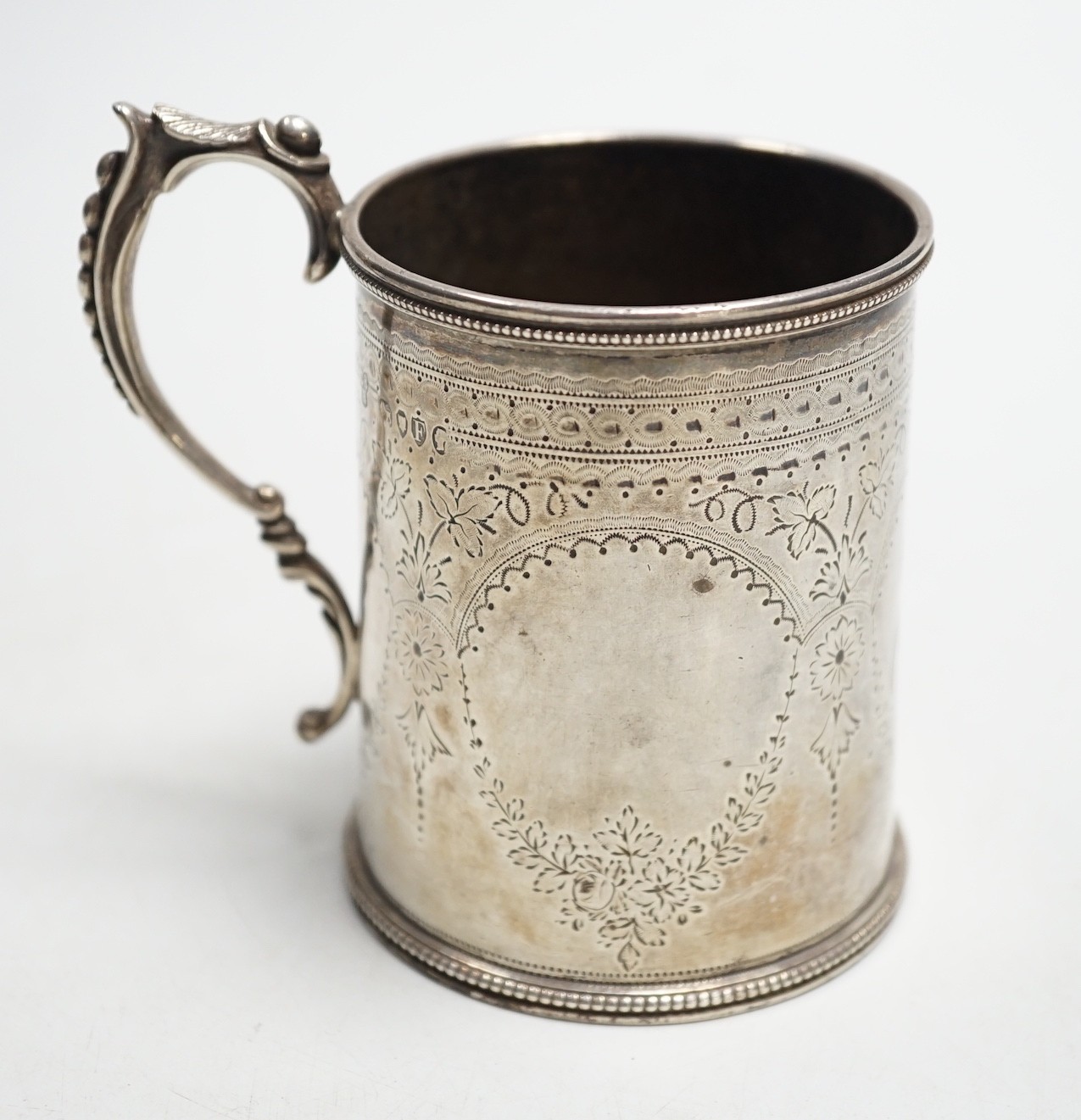A Victorian engraved silver christening mug, Charles Stuart Harris, London, 1881, height 92mm, with engraved monogram.